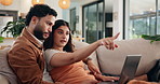 Couple, relax and laptop in home for discussion, online shopping and purchase furniture together. Man, woman and computer on sofa for interior design on internet, decision and pointing at decoration