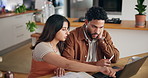 Couple, laptop and discussion with documents for finance, bills and planning with taxes in home kitchen. Computer, man and woman with stress for budget, debt and asset management for mortgage payment