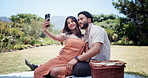 Couple, selfie and picnic with smile at park, blanket and post with memory, hug and outdoor in summer. People, woman and man with photography, love and profile picture for social media in Costa Rica