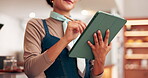 Business owner, woman and writing on tablet in restaurant for inventory management, menu planning and schedule. Hospitality, hands and digital app in coffee shop for stock checklist and online order