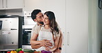 Home, couple and hug with kiss for cooking, support and bonding together with meal prep. Kitchen, man and woman with affection for love, commitment and healthy food with vegetables for vegan salad