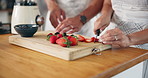 Fruit, berries and hands of couple in kitchen for healthy eating, nutrition and breakfast drink. Home, morning and man and woman with strawberries for smoothie for wellness, organic diet and vitamins