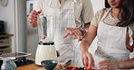 Fruit, strawberry and couple in kitchen with blender for healthy eating, nutrition and breakfast drink. Home, morning and man and woman with berries for smoothie for wellness, organic diet or vitamin