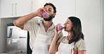 Smile, couple and drink smoothie in kitchen, bonding together and nutrition for healthy diet. People, kiss and nutritionist with organic ingredients for protein juice, weight loss and detox at house