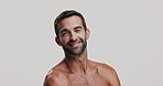 Skincare, happy and face of man in studio for natural, health and facial routine for glow. Portrait, confident and male person from Brazil with hydration dermatology treatment by white background.