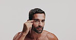 Beauty, face and hydration with shirtless man in studio for antiaging cosmetics, treatment or wellness. Aesthetic, check and skincare with person on white background for morning moisturizing routine