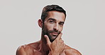 Skincare, hygiene and face of man in studio for natural, health and facial routine for glow. Portrait, confident and male person from Brazil with hydration dermatology treatment by white background.
