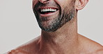 Beard, laughing and teeth of man in studio for cosmetics, dermatology or hygiene closeup. Beauty, mouth or skincare and funny model on white background with satisfaction for results or wellness