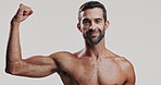Bicep, face and smile with shirtless man in studio for fitness, masculinity or strength. Arm, exercise and muscle with body of confident model on white background for training or workout results