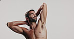 Man, shirtless and flexing biceps in studio with strong muscles, masculinity and bodybuilding progress. Pride, male person and arms for sports workout, training results and growth on white background