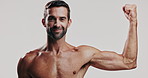 Arm, face and smile with shirtless man in studio for fitness, masculinity or strength. Bicep, exercise and muscle with body of confident model on white background for training or workout results