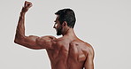 Back, bicep and flexing with shirtless man in studio for exercise, masculinity or strength. Arm, fitness and muscle with body of strong model on white background for training or workout results
