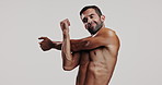 Man, shirtless and stretching arms in studio of strong muscles, masculinity and bodybuilder progress. Pride, male person and warm up for sport workout, training results and growth on white background