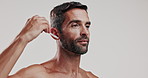 Skincare, face serum and man in studio for natural, health and facial routine for glow. Portrait, confident and male person from Brazil with hydration dermatology treatment by white background.