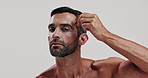 Skincare, tweezer and face of man in studio for natural, health and epilation routine. Portrait, confident and male person from Brazil with eyebrow hair removal treatment by white background.