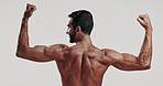 Back, biceps and flexing with shirtless man in studio for exercise, masculinity or strength. Arms, fitness and muscle with body of confident model on white background for training or workout results
