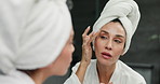 Towels, morning and woman in bathroom, skincare and cosmetics with dermatology. Person, house and reflection with routine, treatment and grooming with beauty, shining and glowing with wellness