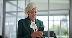 Mature, happy woman and typing with phone for funny joke, conversation or chat at office. Female person, employee or executive with smile on mobile smartphone for business network or social media app