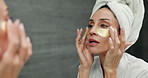 Eye patches, skincare and woman in bathroom, home and treatment for dark circles, shine and wellness. Aesthetic, apartment or person with cosmetics product, beauty and glow with grooming or soft skin