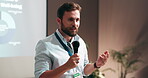 Businessman, presentation and screen with mic for workshop convention, conference or group seminar. Male person, speaker or speech with audience for introduction, company mission or goals at office