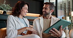 Bonding, smile and couple with tablet, home and watching movies on app in living room and browsing. House, woman and man with tech for streaming, entertainment and relax in lounge, romance or happy