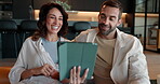 Bonding, laughing and couple with tablet, home and watching movies on app in living room or browsing. House, woman and man with tech for streaming, entertainment and relax in lounge, romance or happy