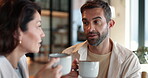 Couple, talk and drink coffee in kitchen with funny joke, bonding together and morning breakfast. People, discussion and caffeine beverage of weekend break, marriage commitment and wellness at house 