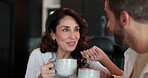 Smile, couple and talk with coffee in kitchen for storytelling, bonding together and morning breakfast. People, discussion and caffeine drink for weekend break, marriage commitment and love at house 