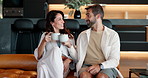 Home, couple and cheers with coffee for bonding, healthy relationship and relax with espresso on sofa. Happy, woman and man with tea for morning drink, conversation and partner with phone in house