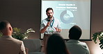 Businessman, presentation and screen with mic for seminar, conference or group convention at office. Male person, speaker or speech with audience for mental health training or wellbeing at workshop