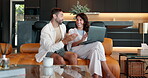 Laptop, talking and smile with couple on sofa for joint bank account, savings fund and planning. Morning, loan application and credit sign up with man and woman in living room at home for research
