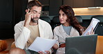 Couple, documents or finance with laptop on sofa for budget planning, expenses or bills at home. Man, woman or discussion with paperwork on computer for financial payments, costs or mortgage at house