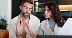 Frustrated couple, documents or finance with laptop on sofa for debt, bankruptcy or missed payments at home. Man, woman or paperwork with argument for financial crisis, bills or expenses at house