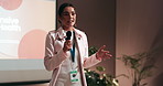 Business woman, presentation and screen with mic for seminar, meeting or conference at office. Female person, speaker or career discussion with staff or audience for explanaion or speech at workplace