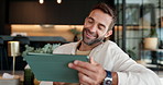 Home, internet and man on sofa, tablet and typing with email notifications, connection and network. Happy person, apartment and guy with tech, communication and social media in living room and app