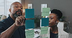 Man, woman and finance with notes, glass wall and advice for project, brainstorming and review in office. People, mentor and learning with writing, feedback and planning budget at creative agency