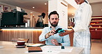 Man, waiter and customer with phone on pos machine at cafe for payment or wirelesss transaction. Male person, purchase and mobile smartphone with tap for fintech, drink or checkout at coffee shop