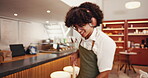 Music, man and cleaning cafe with headphones for sweeping playlist, maintenance and hygiene. Happy barista, broom and listening to radio for dirt removal, coffee shop disinfection or dancing to audio