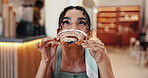 Woman, croissant and eating pastry in coffee shop, hungry and bite of delicious snack in bistro. Sweet food, female person and bakery customer with confectionery craving, meal and local restaurant