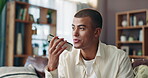 Home, speaker and man with smartphone, talking and voice message on social media in living room or relax. House, digital and communication with contact in lounge, break or person with mobile for chat