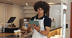 Tablet, man and waiter in coffee shop for inventory checklist online for order with supplier. Stock, restaurant and male barista with digital technology for website update with menu in cafeteria. 