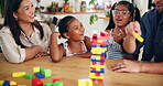 Home, parents and kids with toys for game, cognitive development and bonding together as family. Kitchen, mother and father with children for puzzle blocks, playing and creativity with logic in house