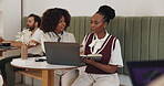 Business people, writing and discussion with laptop in cafe, article information and teamwork. Coffee shop, smile and women as journalists with digital, blog notes or angle solution for press release