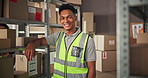 Face, logistics worker and happy man in warehouse for shipping, supply chain or ecommerce. Portrait, distribution and person with safety vest at shelf or procurement professional in fashion business