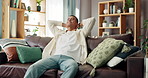Comfort, relax and smile with man on sofa in living room of home for break, rest or weekend. Calm, chill and hands behind head with happy person in apartment for satisfaction or stress relief