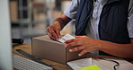 Small business, boxes and hands with order, label and preparing for shipping with info and logistics. Warehouse, entrepreneur and person with stock for supply chain, ecommerce or plan for online shop