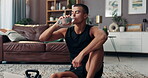 Relax, fitness and drinking water with man in living room for exercise, hydration and health. Workout, wellness and resting with person on floor of home gym for sports, bodybuilder and thirsty