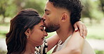 Happy, forehead kiss and couple in park for bonding, dating and commitment on weekend. Nature, love and man and woman embrace for affection, relationship and hug for romance, trust and care outdoors