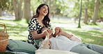 Love, happy couple and laugh at park for picnic, connection or relax together on date for chat. Man, woman and holding hands outdoor for romantic relationship, playful and embrace with funny partner