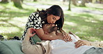 Love, couple and kiss on nose at park for picnic, connection or relax together on date for chat. Man, woman and embrace outdoor for romantic relationship, marriage or support with partner on vacation